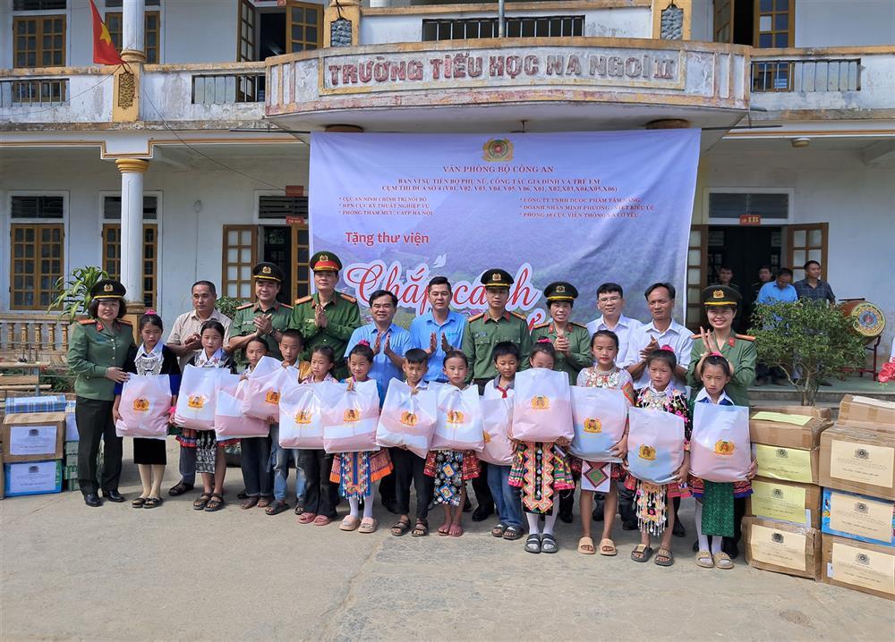Delegates present warm clothes to local children.