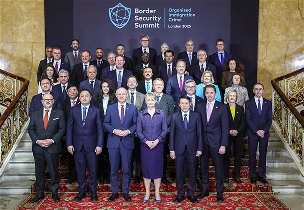 Delegates join group photo.