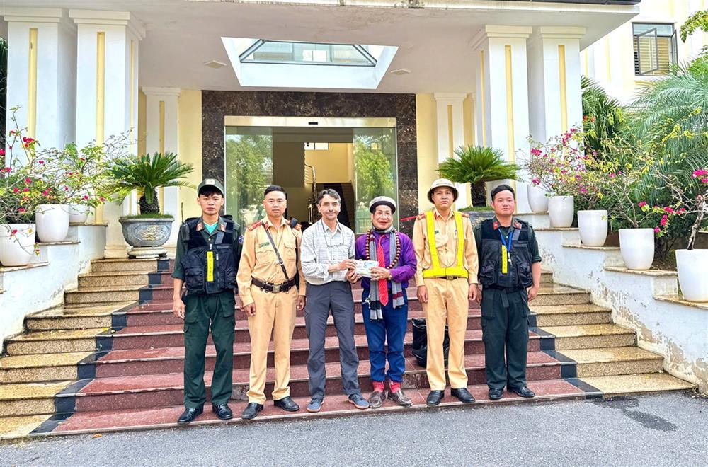 Traffic police officers return lost item to Mr. Pattrick Michel Tomas.
