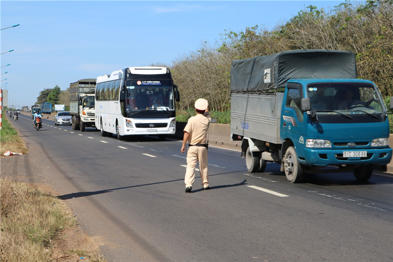 Traffic police officers checks cars and trucks.